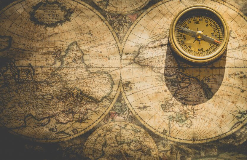 an old world map and a compass